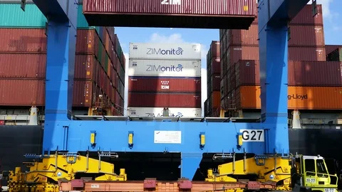 Gantry crane is unloading a container from a ship at daytime Video stock 92591788