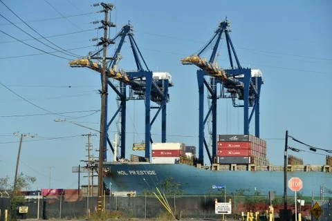 Gantry cranes unloading a ship Stock Photos