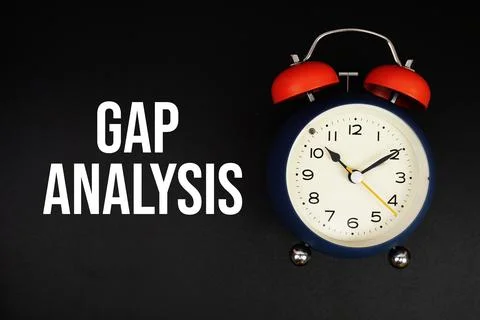 Gap Analysis text with alarm clock on black background Stock Photos