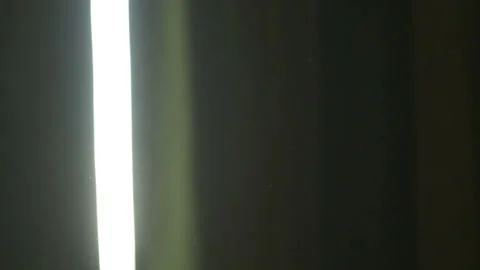 The gap between the green curtains lets in sunlight, which illuminates the du Stock Footage 150188744