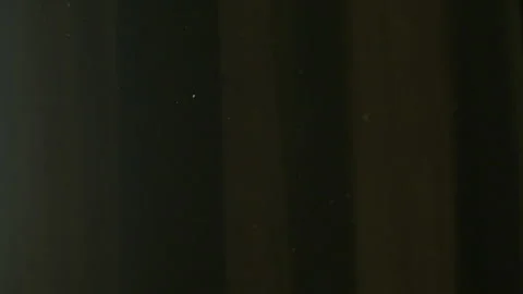 The gap between the green curtains lets in sunlight, which illuminates the du Stock Footage 150188747