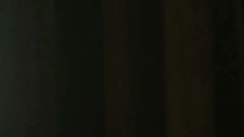 The gap between the green curtains lets in sunlight, which illuminates the du Stock Footage 150188777