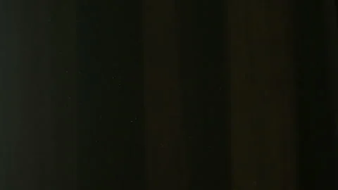 The gap between the green curtains lets in sunlight, which illuminates the du Stock Footage 150188785