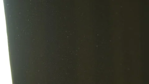 The gap between the green curtains lets in sunlight, which illuminates the du Stock Footage 150188841