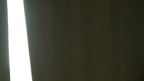 The gap between the green curtains lets in sunlight, which illuminates the du Stock Footage 150188922