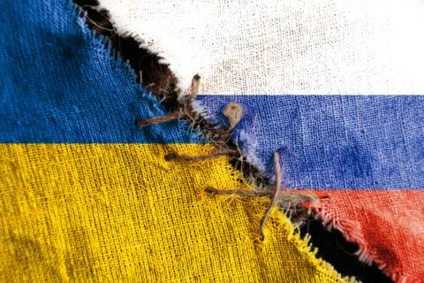 The gap between the two flags, Russia  and Ukraine, sewn with threads, as the Stock Photos