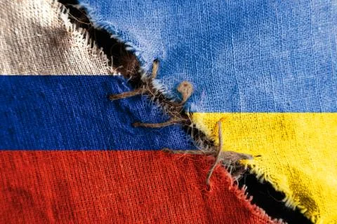The gap between the two flags, Russia  and Ukraine, sewn with threads, as the Stock Photos