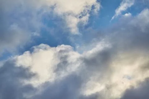 A gap through the clouds, a clear sky is visible through the clouds Stock Photos