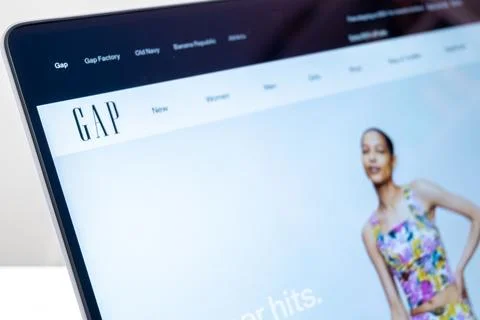 GAP website displayed on a laptop screen featuring a model wearing summer c.. Fotos de archivo