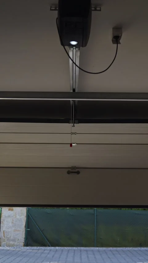 Garage door closes with automatic opener, viewed from inside the garage Stock Footage 334075013