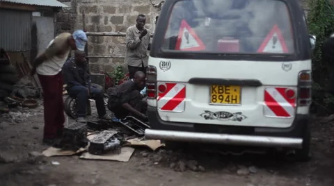 Garage mechanics working on car engine, Kenya, Africa Stock Footage 52130814