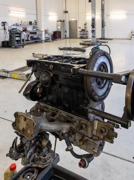 In the garage there is an opened engine block of a car Stock Photos