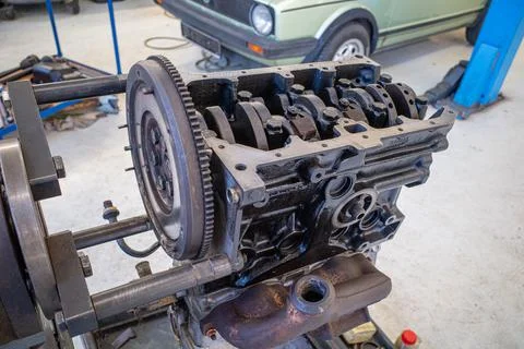 In the garage there is an opened engine block of a car Stock Photos