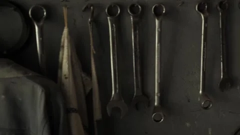 Garage tools denim jacket and end wrenches pan right Stock Footage 195999632