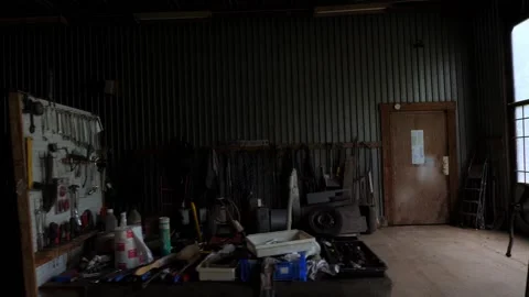 Garage Tools on table in dark garage pan left Stock Footage 195999665