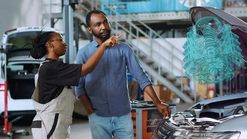 Garage worker projects car motor with AR Photos