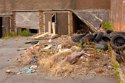 Garages with rubbish fly tipped Stock Photos