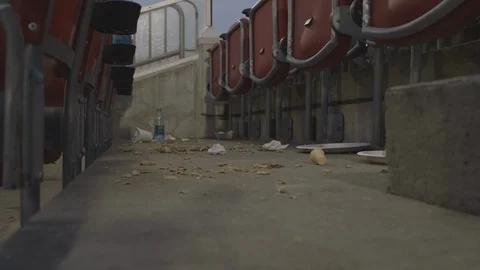 Garbage and Debris In Seating Row Of Stadium Stock Footage 118095448