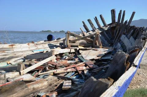  garbage and trash inside broken old wooden ship of blue and white color Stock Photos