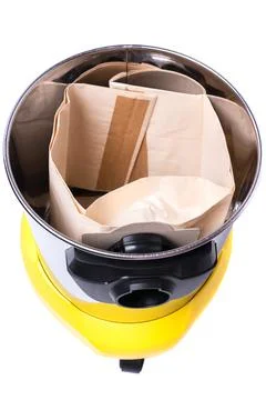 Garbage bag installed inside a yellow construction vacuum cleaner Stock Photos