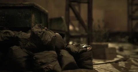 Garbage bags piled in a dimly lit abandoned warehouse setting Stock Illustration