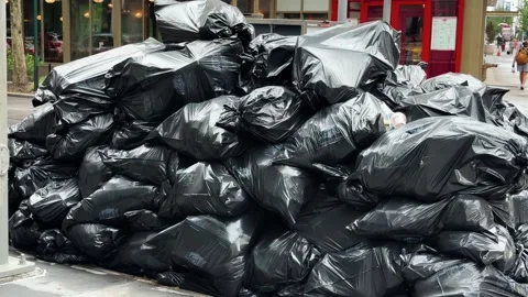 Garbage Bags Piled High on Brooklyn Sidewalk at City Street Corner in New York Stock Footage 341128674