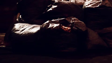 Garbage bags stacked in a dark area in the evening Video stock 340978208