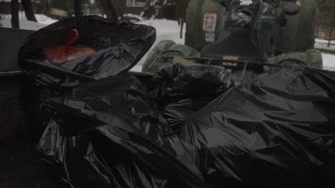 Garbage bags in utility trailer during winter cleanup Stock Footage 327966295