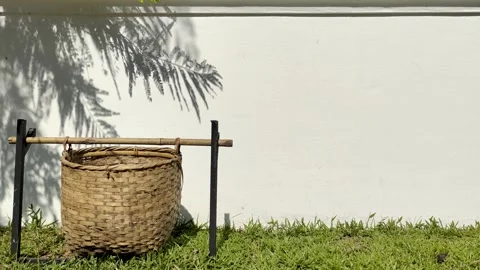 Garbage basket, trash basket made of bamboo Infront of gray wall  Video stock 252885575