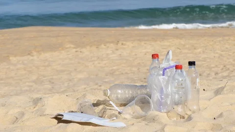 Garbage at the beach hurting the beautiful environment Видео 109074710