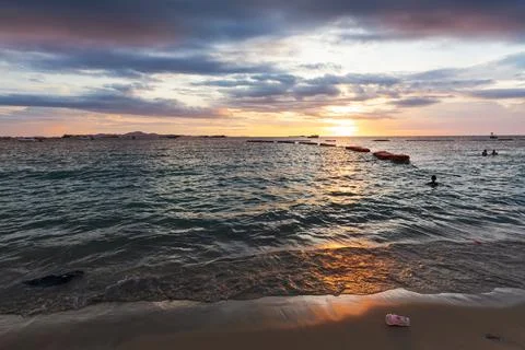 Garbage on the beach in sunset light Stock Photos