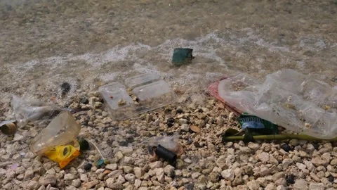 Garbage being washed to the shoreline Stock Footage 300669239