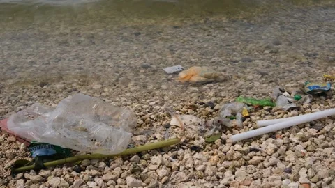 Garbage being washed to the shoreline Stock Footage 300669249
