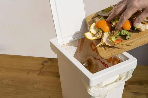The garbage into the bin a man as he throws the garbage into the bin Copyr... Stock Photos