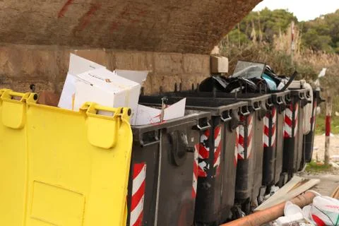 Garbage bins overflowing angled view Stock Photos