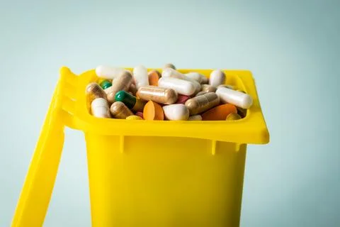 Garbage can full of pills, Concept, medical waste, Disposal of expired drugs Stock Photos