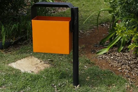 Garbage can installed in public space garden Stock Photos