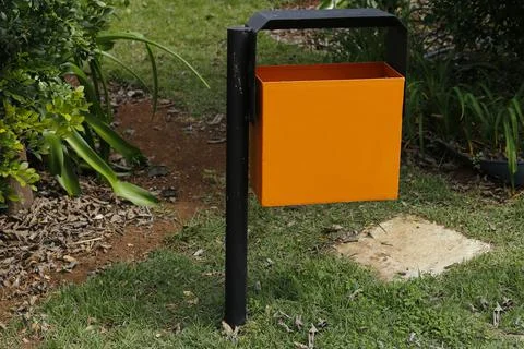 Garbage can installed in public space garden Stock Photos