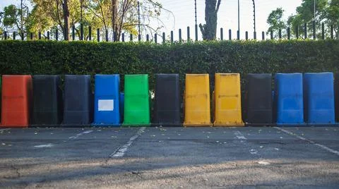 Garbage cans of different colors are turned upside down in row. Foto stock