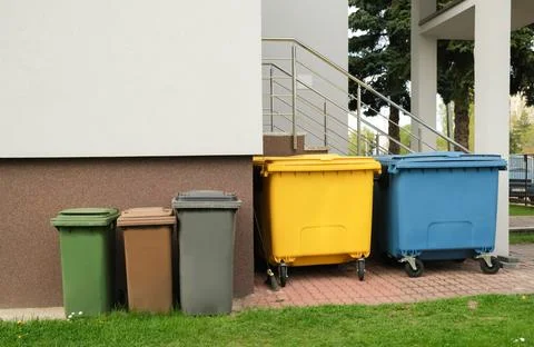 Garbage cans stand on the street Stock Photos