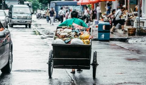 Garbage in China. Scavenger pulls a trash cart Stock Photos