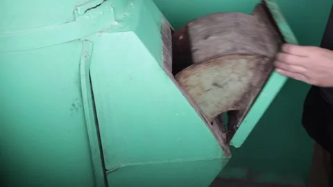 The garbage chute in the house. A man throws cigarette butts in the trash Stock Footage 230985548
