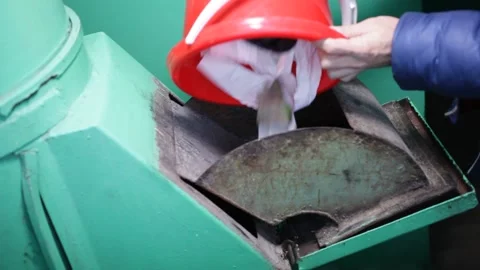 The garbage chute in the house. A man throws waste from a red bucket Stock Footage 230985549