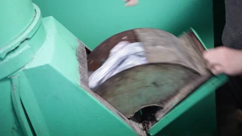 The garbage chute in the house. A man throws waste in a gray bag Stock Footage 230985557