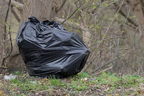 Garbage in the city park.A large garbage bag after cleaning the park by eco.. Stock Photos