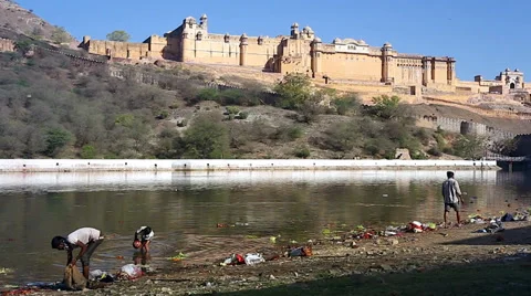 Garbage is collected from a sacred pool in front of Amer Fortress in India. Stock Footage 37511998