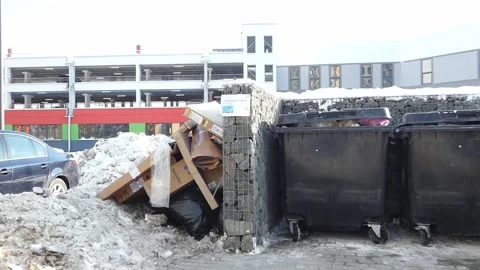 Garbage collection area with cardboard and snow on a winter day in a city parkin Stock-Footage 328425990