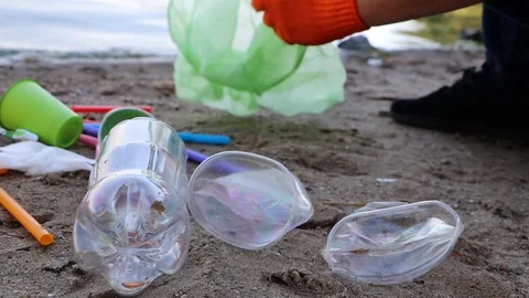 Garbage collection on the beach. Plastic and packages scattered on the beach. A  Video stock 111644796