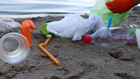 Garbage collection on the beach. Plastic and packages scattered on the beach. A  Stock Footage 111644987