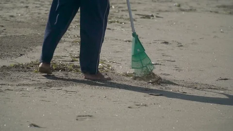 Garbage collection on the beach with a rake close-up Stock Footage 126969630